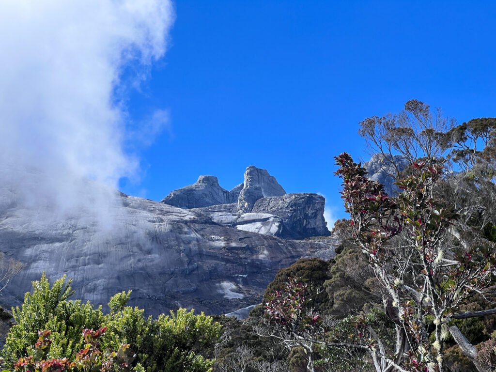 Granite peaks revealing themselves on Mount Kinabalu trail, nearing Panalaban Base Camp. © SlowingwithT.com