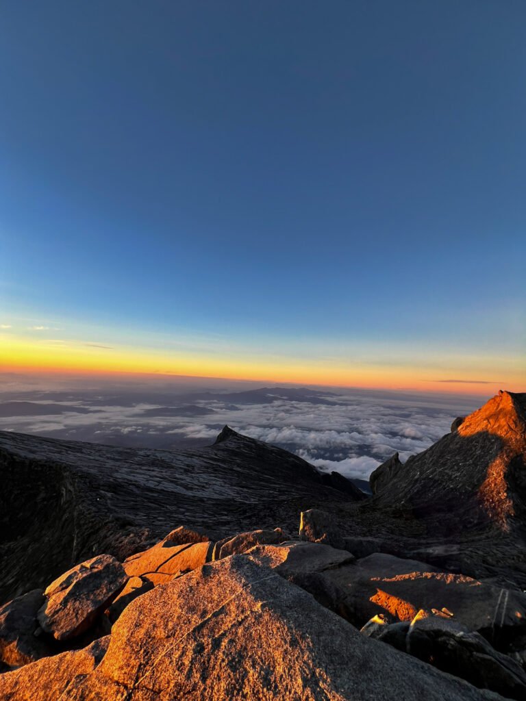 Sunrise view from Mount Kinabalu summit - South Peak in the distance © SlowingwithT.com